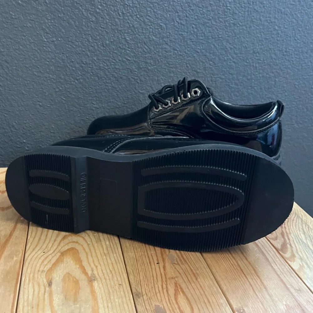 All black leather platform low top laced up boots